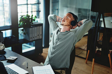 Aufkleber - Listening to my favourite podcast. Shot of a young businessman wearing headphones while taking a nap in an office.