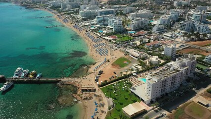 Wall Mural - Flying over the Mediterranean Sea beach and hotels in tourist Protaras, Cyprus, aerial video