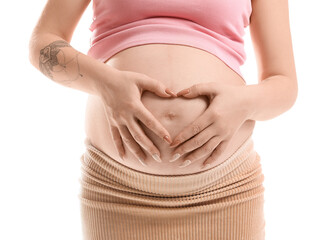 Wall Mural - Pregnant woman making heart shape with her hands on belly against white background, closeup