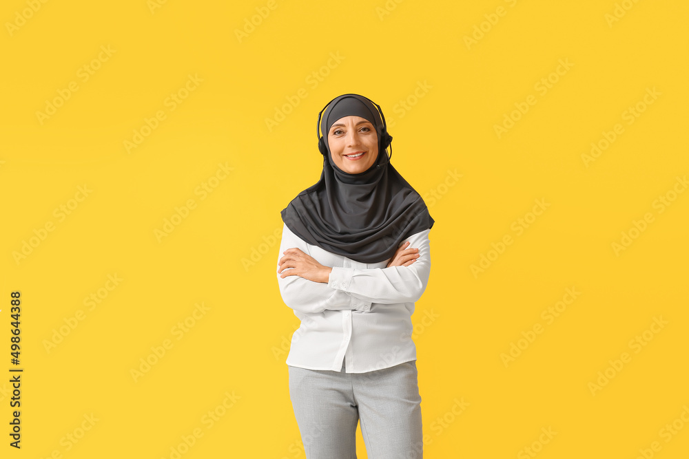Muslim secretary with headset on color background