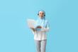 © Pixel-Shot - Muslim secretary with headset and laptop on color background