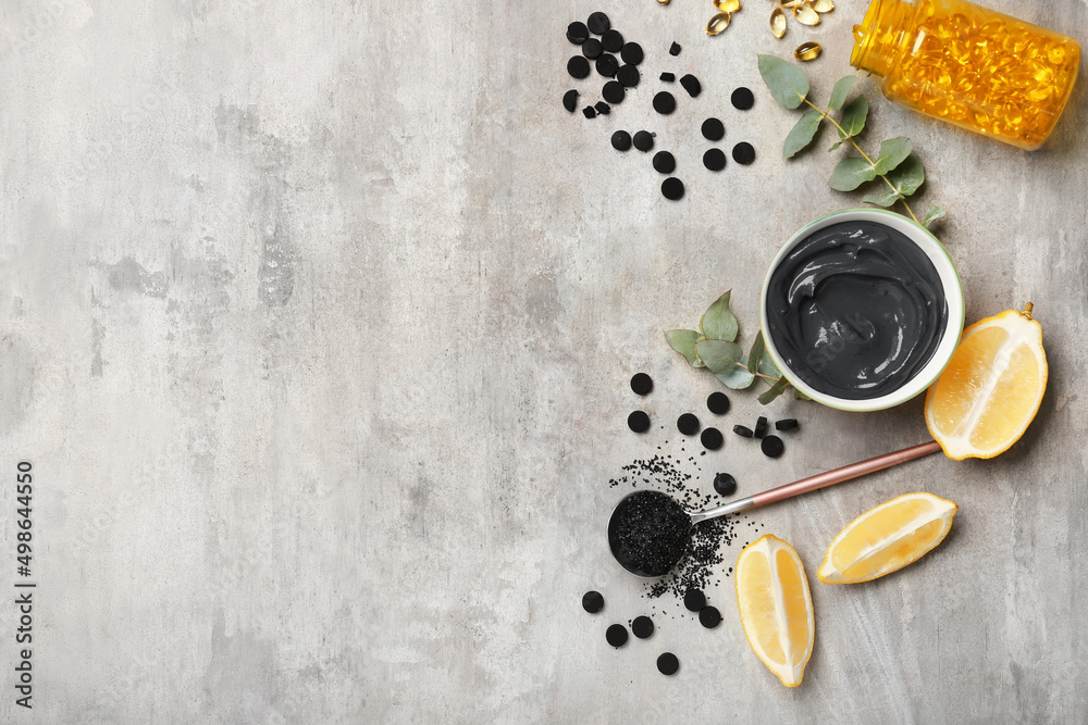 Composition with ingredients for preparing activated carbon facial mask on grunge background