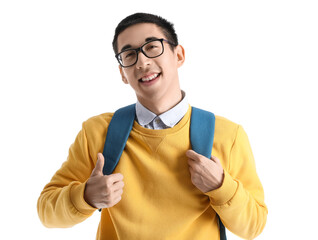 Wall Mural - Male Asian student in eyeglasses with backpack showing thumb-up on white background