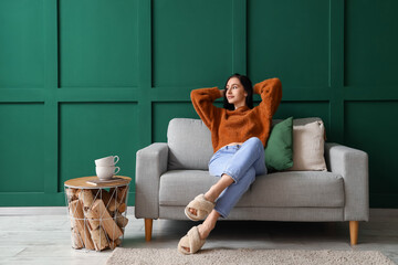 Wall Mural - Beautiful young woman resting on couch at home