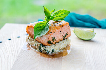 Poster - Salmon steak on the grill with risotto on the board