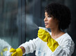 © Michael C/peopleimages.com - I guess its time to clean my windows. Shot of a young woman cleaning her windows.