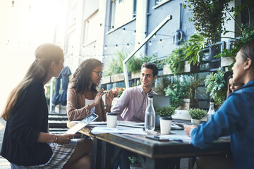 Aufkleber - Productive meetings done over a cup of coffee. Shot of a group of designers having a meeting at a coffee shop.