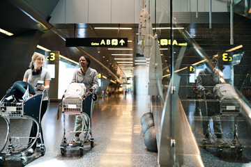 Aufkleber - Our bags are packed and were ready to go. Full length shot of two attractive young women walking through an airport.