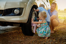 Theyre Always Eager To Help Dad Wash The Car. Shot Of A Family Washing Their Car Together.