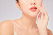 © Tuan  Nguyen  - A close view of model showing lip posing with hand for cosmetic advertising