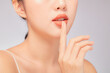 © Tuan  Nguyen  - A close view of model showing lip posing with hand for cosmetic advertising