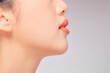 © Tuan  Nguyen  - A close view of model showing lip posing with hand for cosmetic advertising