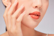 © Tuan  Nguyen  - A close view of model showing lip posing with hand for cosmetic advertising