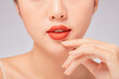 © Tuan  Nguyen  - A close view of model showing lip posing with hand for cosmetic advertising
