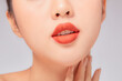 © Tuan  Nguyen  - A close view of model showing lip posing with hand for cosmetic advertising
