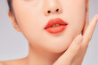 © Tuan  Nguyen  - A close view of model showing lip posing with hand for cosmetic advertising