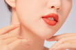 © Tuan  Nguyen  - A close view of model showing lip posing with hand for cosmetic advertising