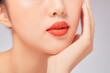 © Tuan  Nguyen  - A close view of model showing lip posing with hand for cosmetic advertising