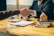 Leinwandbild Motiv Sales representatives shake hands with customers and offer home purchase contracts to purchase current homes and leases offer homeowners projects upon signing of contract with insurance.