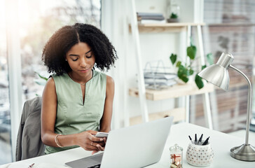 Poster - Shes easy to get a hold of. Cropped shot of an attractive young businesswoman sending a text message while working at her desk in the office.