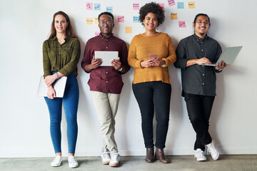 Poster - Were keeping the connection going strong. Full length shot of a group of a young businesspeople standing together and using their digital devices at work.