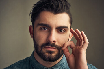 Poster - Because a man should look like a man. Cropped shot of a young man twirling his mustache.