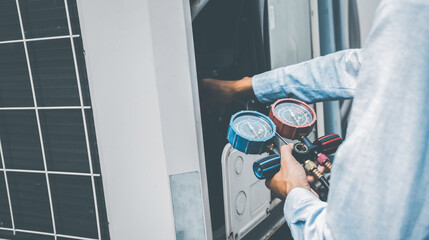 air repair mechanic using measuring equipment for filling indust