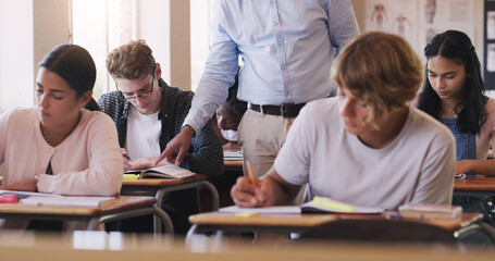 Poster - Make today the day you learn something new. Shot of teenage boy asking his teacher for help during an exam in a classroom.