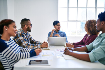 Poster - Were here to raise the bar. Cropped shot of a team of designers brainstorming together in an office.