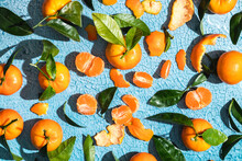 Tangerines And Leaves With Peel On Cracked Background