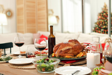 Canvas Print - Festive dinner with delicious food and wine on table indoors. Christmas celebration