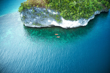 Poster - Cruising around the island in a canoe is the best. High angle shot of two adventurous young couples canoeing together in the beautiful oceans of Indonesia.