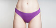 midsection of woman wearing purple cotton panties as women's health concept