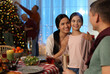 © New Africa - Happy family celebrating Christmas at home in evening