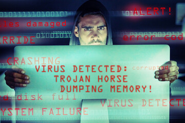 Fototapete - Your computer could become your worst enemy. Portrait of a serious computer hacker using a computer in the dark.
