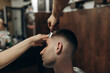 man getting his hair cut at barbershop