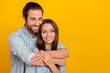 © deagreez - Photo of sweet young brown hairdo couple hug wear blue shirt isolated on yellow background