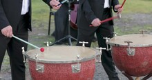 Two Male Musicians Black Tuxedos Play Timpani Nature Grass. Hit With Sticks