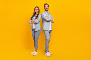 Wall Mural - Photo of pretty adorable husband wife wear jeans shirts smiling arms folded isolated yellow color background