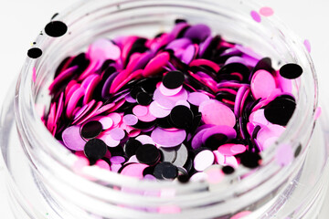 Poster - colored sequins in a plastic jar close-up