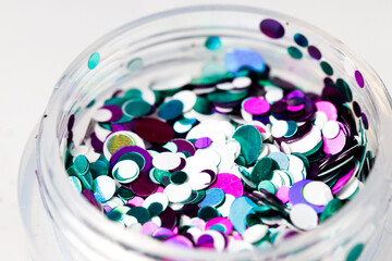 Poster - colored sequins in a plastic jar close-up