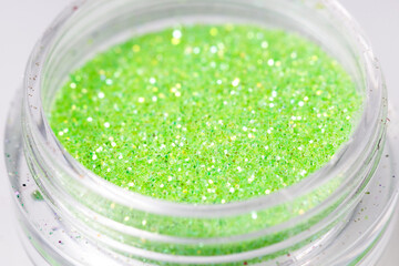 Poster - colored sequins in a plastic jar close-up