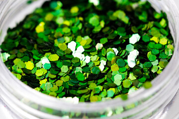 Poster - colored sequins in a plastic jar close-up