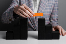 Businesswoman Building Bridge With Colorful Blocks At Table, Closeup. Connection, Relationships And Deal Concept