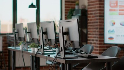 Poster - Nobody in telemarketing office used for call center job, giving assistance and support to clients on phone helpline. No people at customer service desk with headsets and monitors.