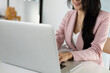 © Wasan - Business woman or secretary working with laptop in business office.