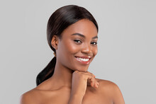 Portrait Of Smiling Pretty Millennial African American Woman With Shining Hair And Perfect Skin Looking At Camera