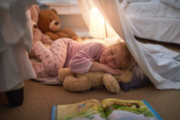 Goodnight, sleep tight. Cropped shot of a little girl sleeping under a blanket fort at home.