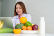 © Prot - Portrait of Asian smiling female nutritionist typing on laptop computer for balanced corrective diet plan for patient or weight loss advice. Concept of healthy lifestyle, healthy food, dieting