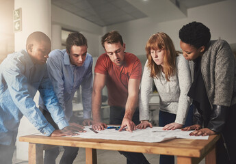 Poster - Collaboration is key. Cropped shot of architects working together on a project in an office.